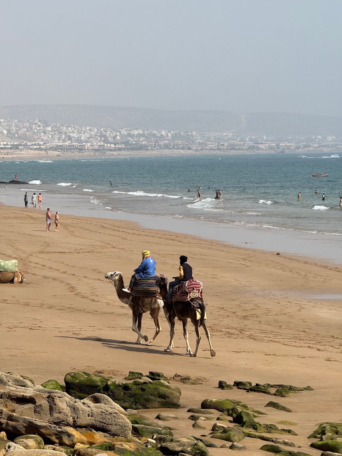 Camel riders on an Atlantic beach in southern Morocco