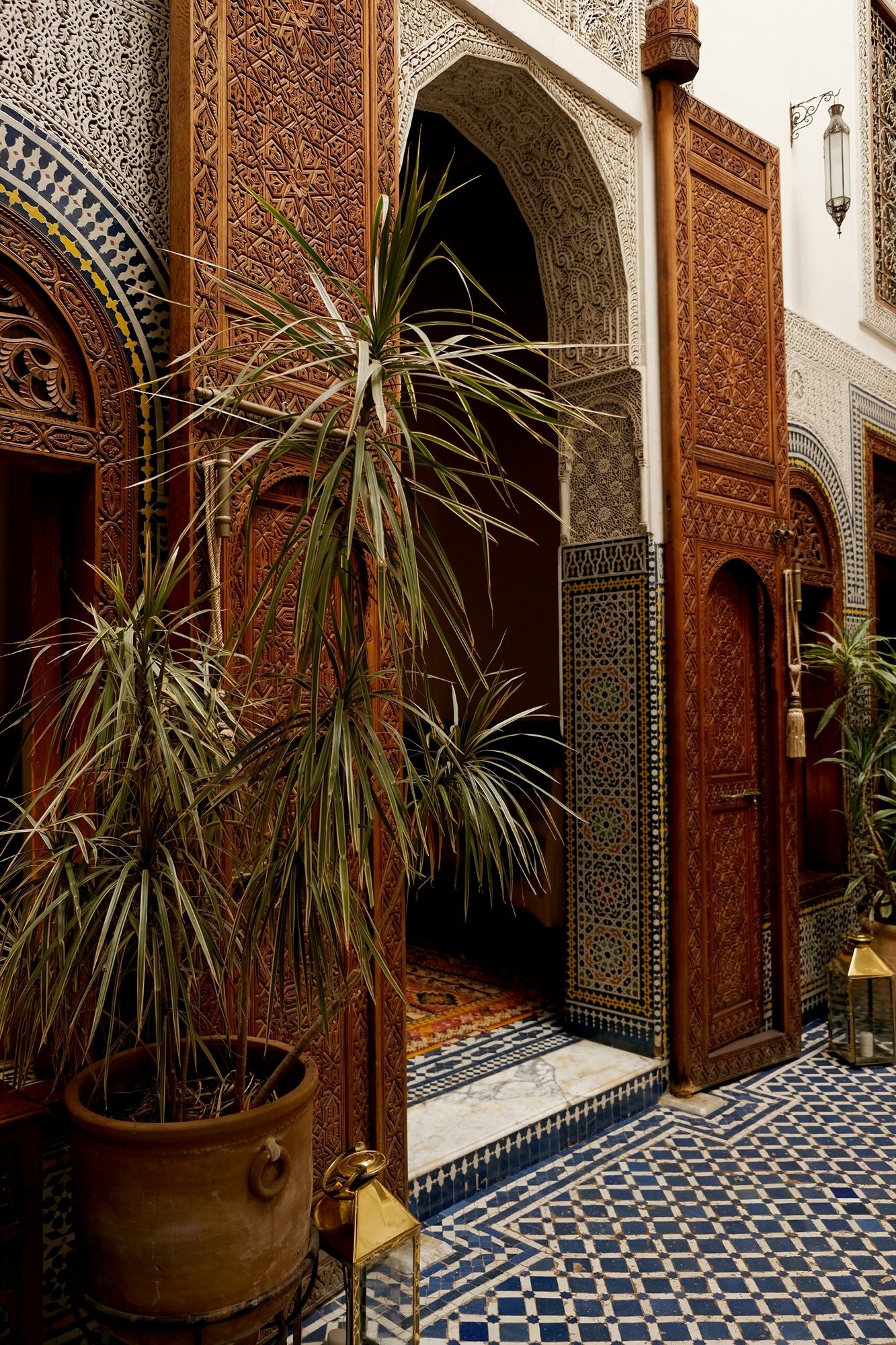 Carved cedar doors and zellige in a Fès riad